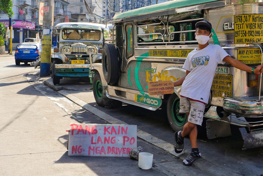 Jeepney driver begging on the street.