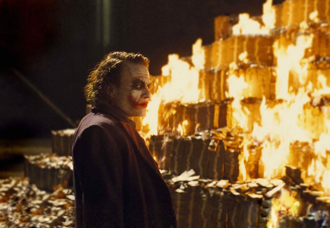 joker burning pile of money