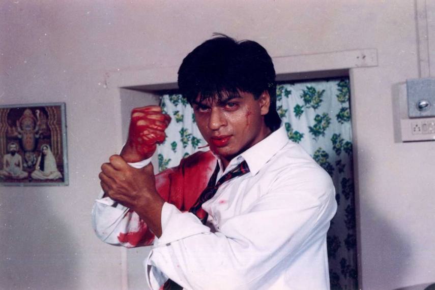 hah Rukh Khan in a still from Baazigar / Photo Credit: Outlook India